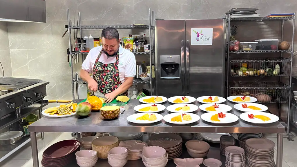 Owner Carlos at Casa Batsu preparing breakfast fruit plates